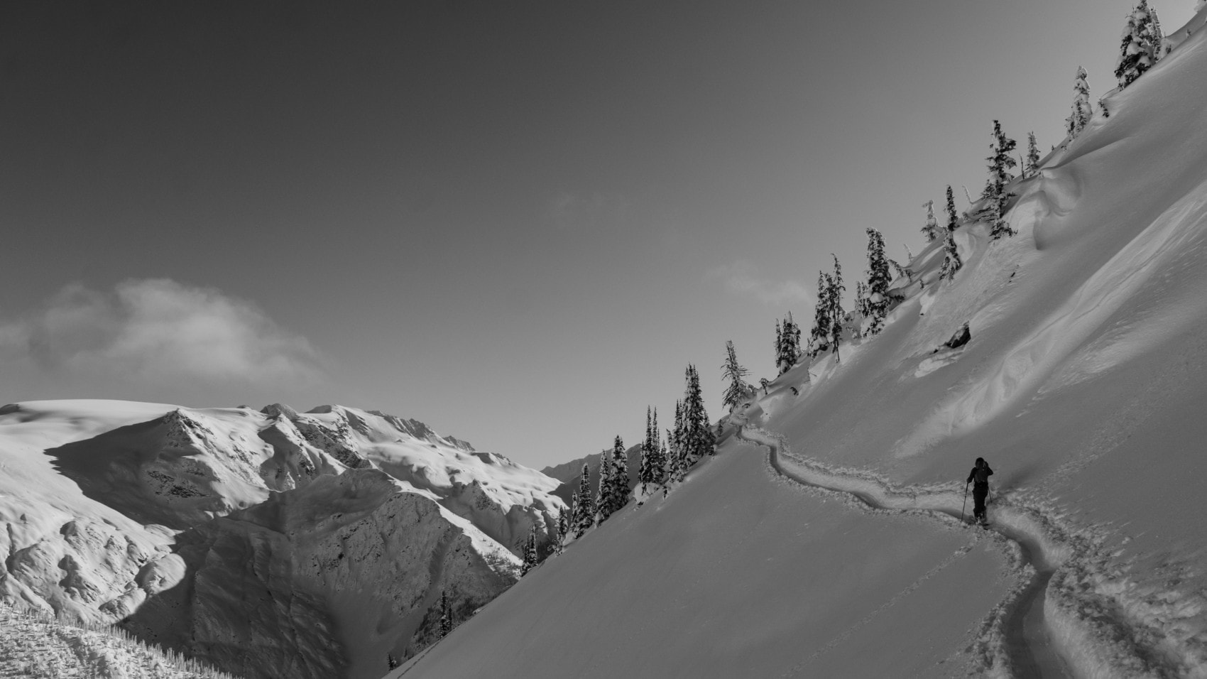 skier climbing avalanche crest