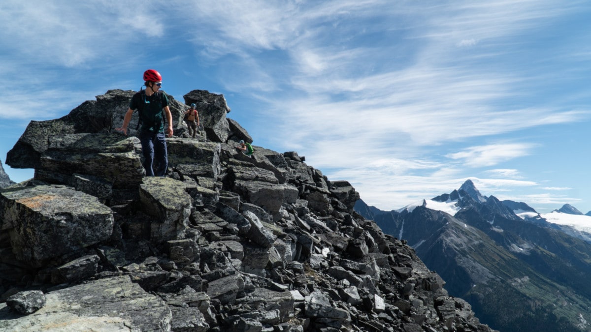 climbers walking along a ridge in rogers pass