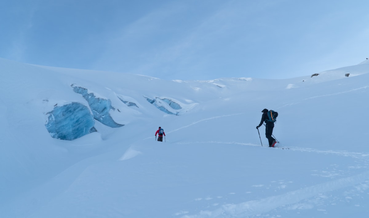 two mountaineers touring by glacial ice