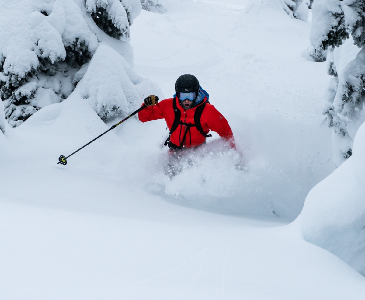 skier bursting through a powdery pocket of snow