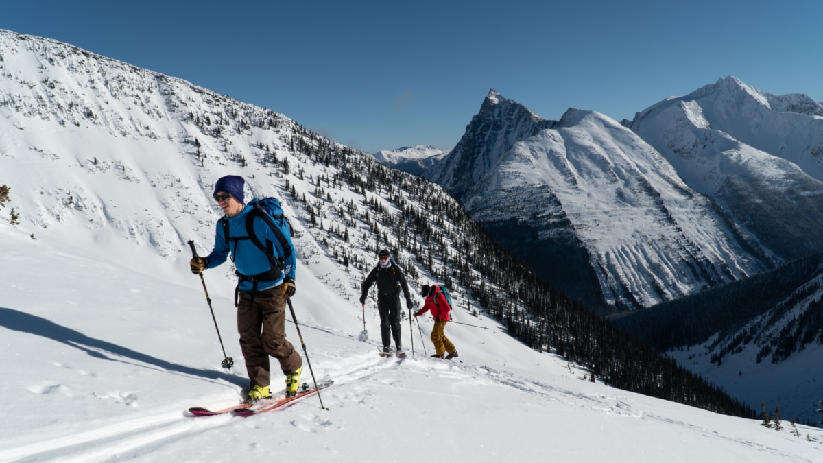 three men climbing a sunlit slope in rogers pass