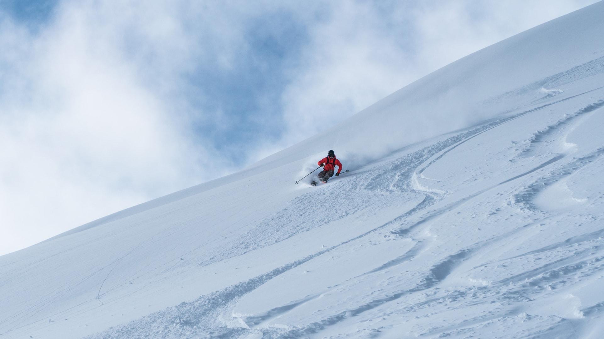 skier carving hard on a mellow alpine face