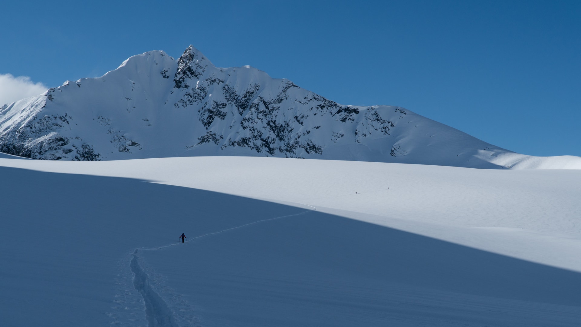 ski tourer ascending the avalanche glacier on the sir donald to macdonald traverse