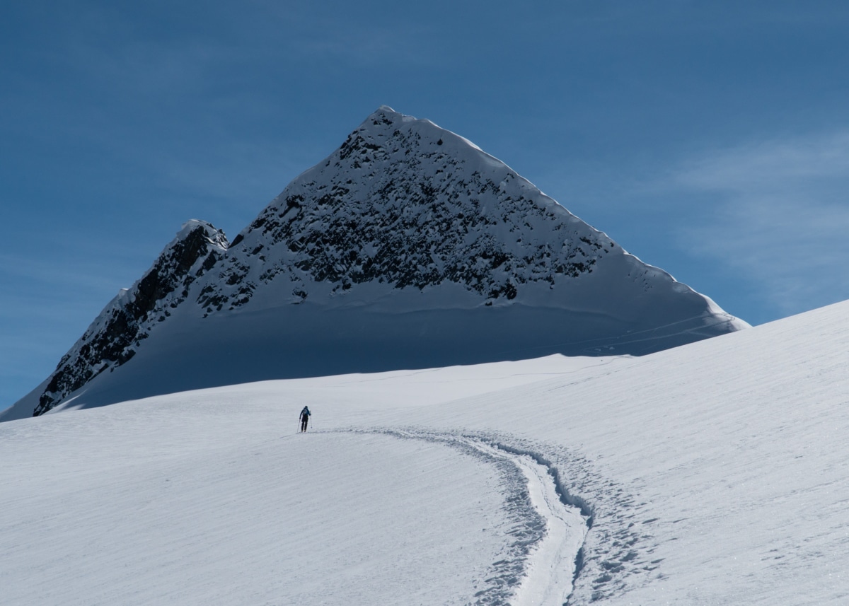 skier touring on the asulkan glacier towards castor peak