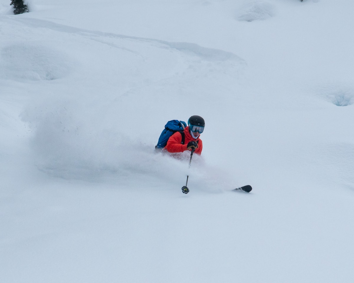 skier backcountry skiing in deep powder