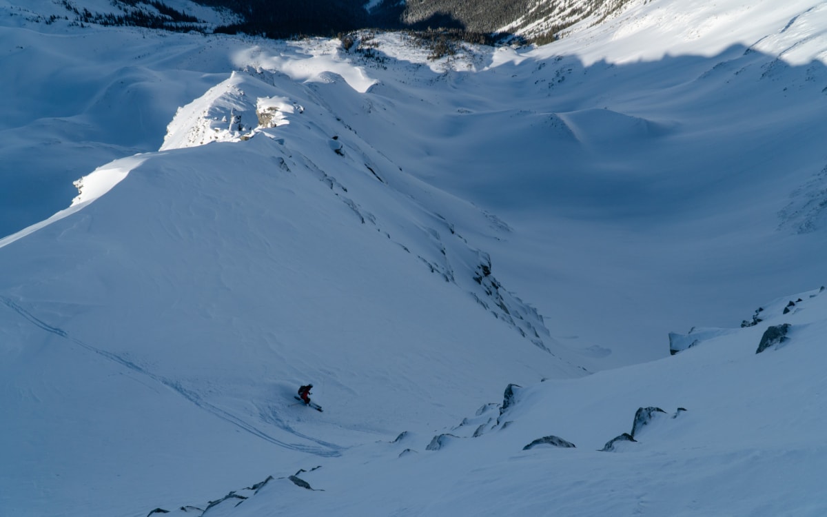 skier skiing the north face of video peak in the shadow