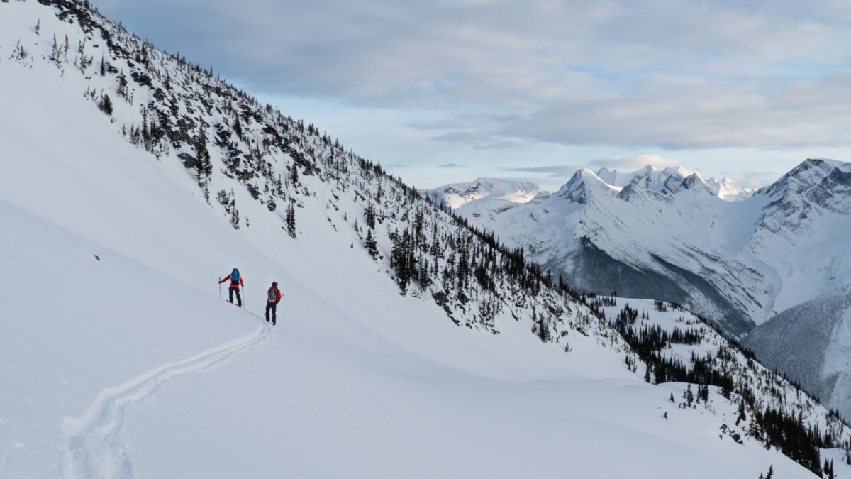 two skiers traversing towards balu pass