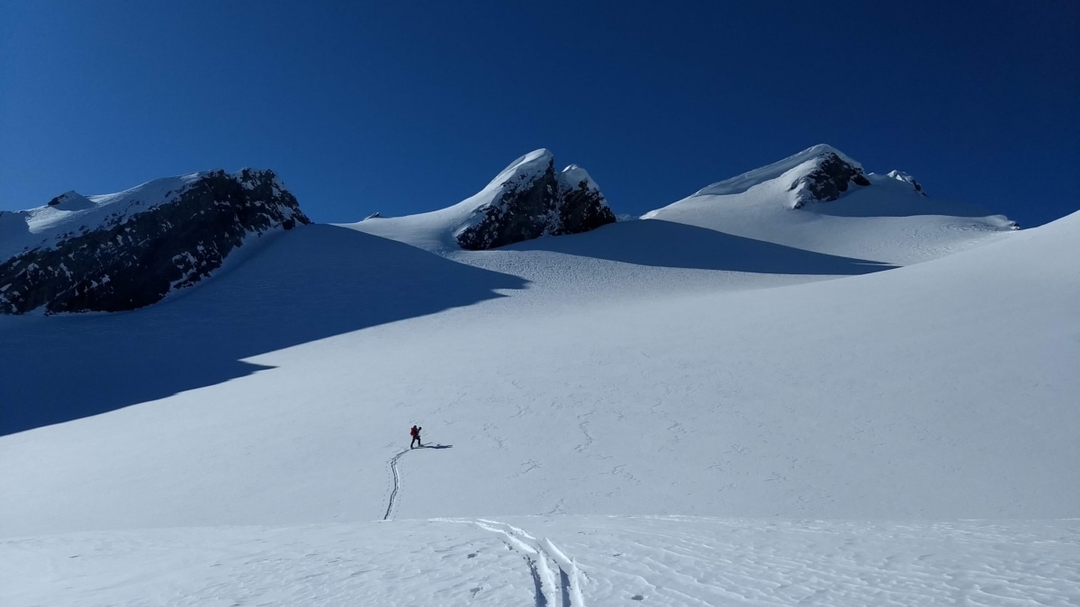 skier touring under mt laforme on its north face