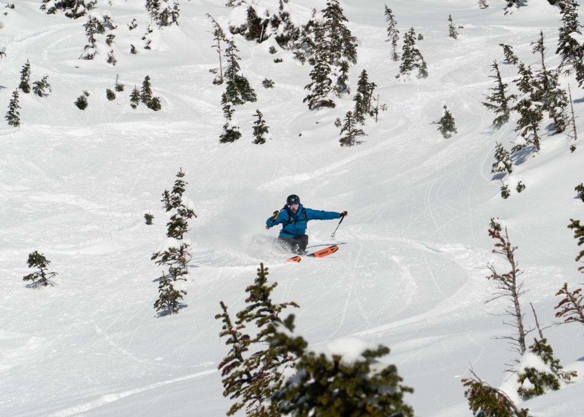 man skiing a steep slope